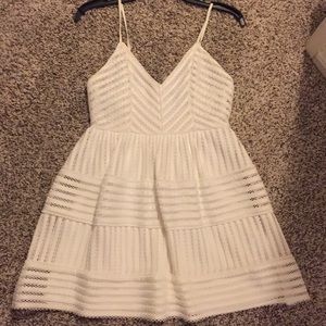 White A line dress. Form fitting in the top.